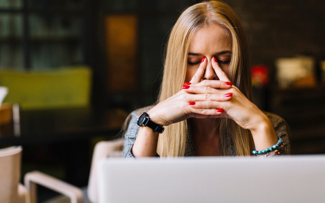 Woman frustrated while using laptop